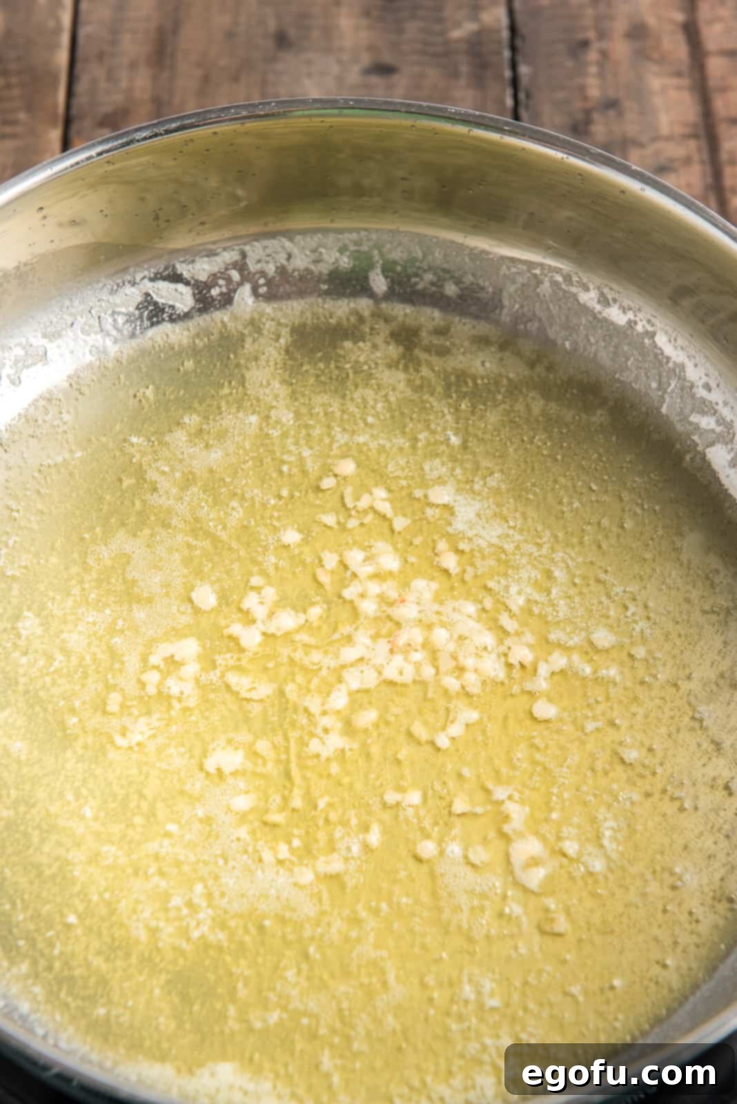 Olive oil, butter and garlic melted in pan, ready for the next steps.