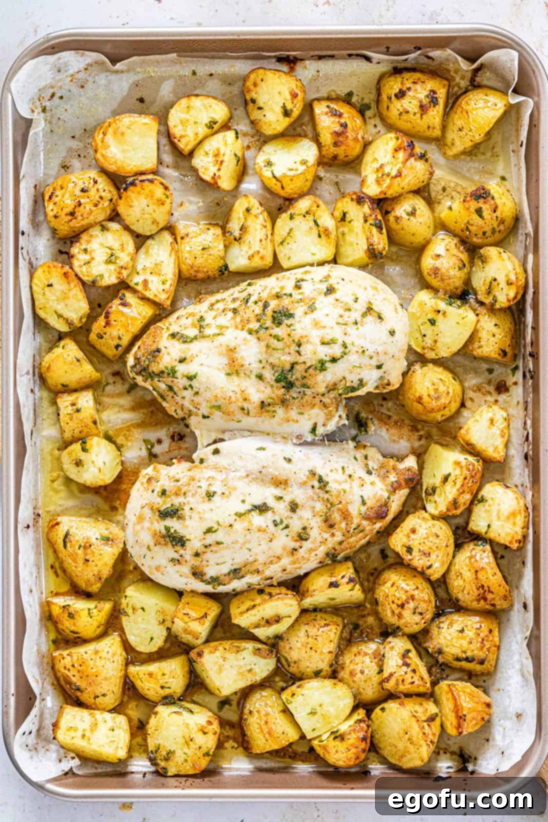 Garlic Butter Sheet Pan Chicken Dinner 11 Cooked potatoes and chicken on sheet pan.