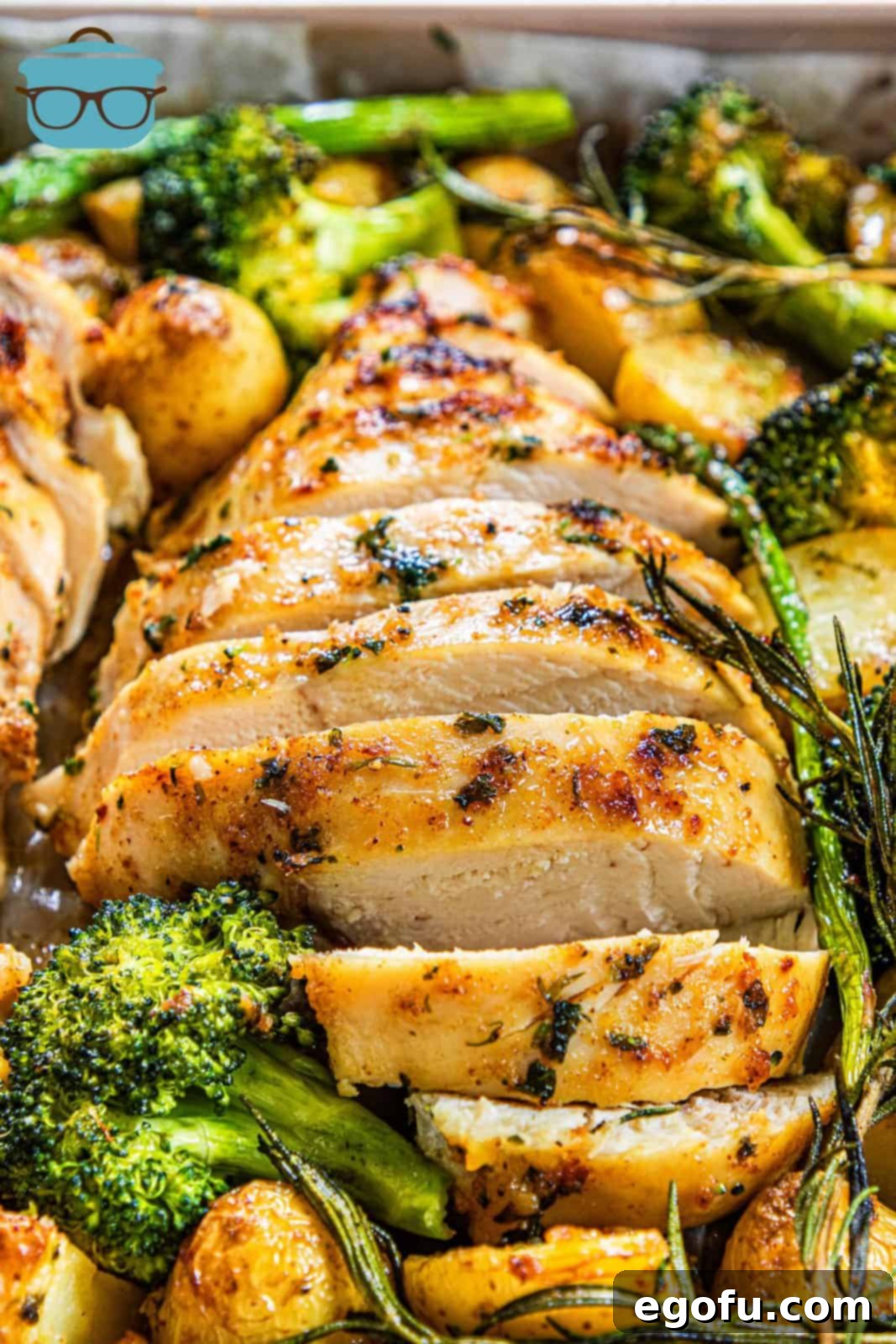 Garlic Butter Sheet Pan Chicken Dinner 13 Close up of sliced chicken with vegetables on sheet pan.