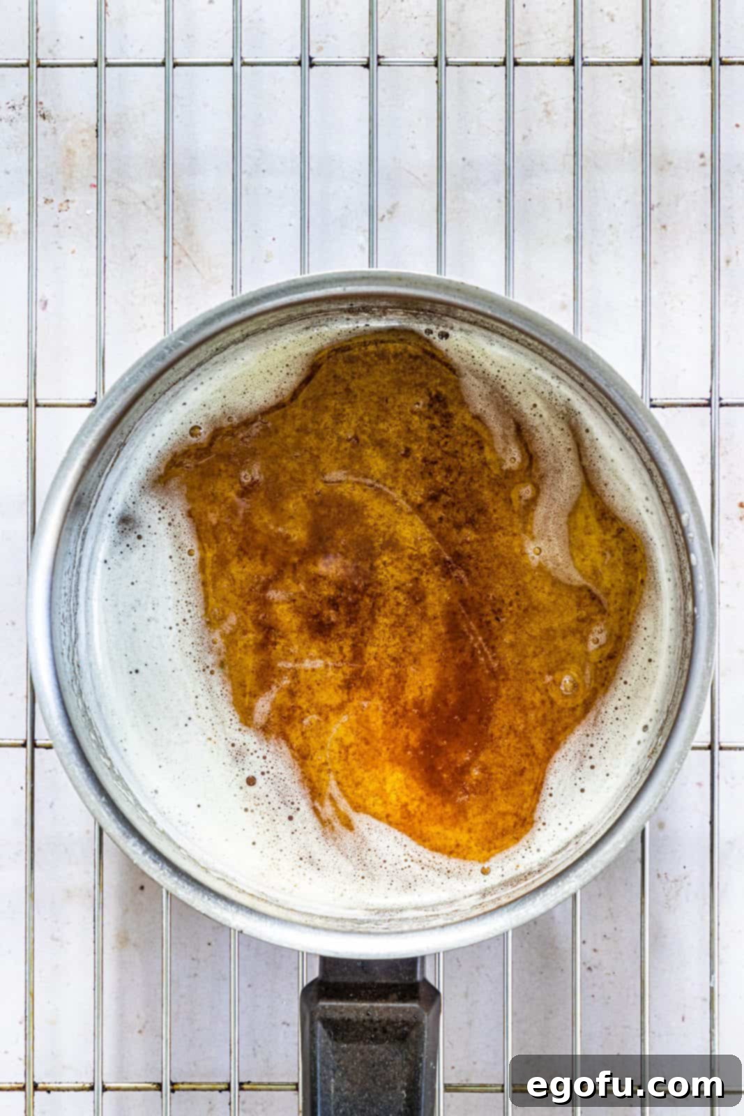 Garlic Butter Sheet Pan Chicken Dinner 7 Melted browned butterr in pan with foam.