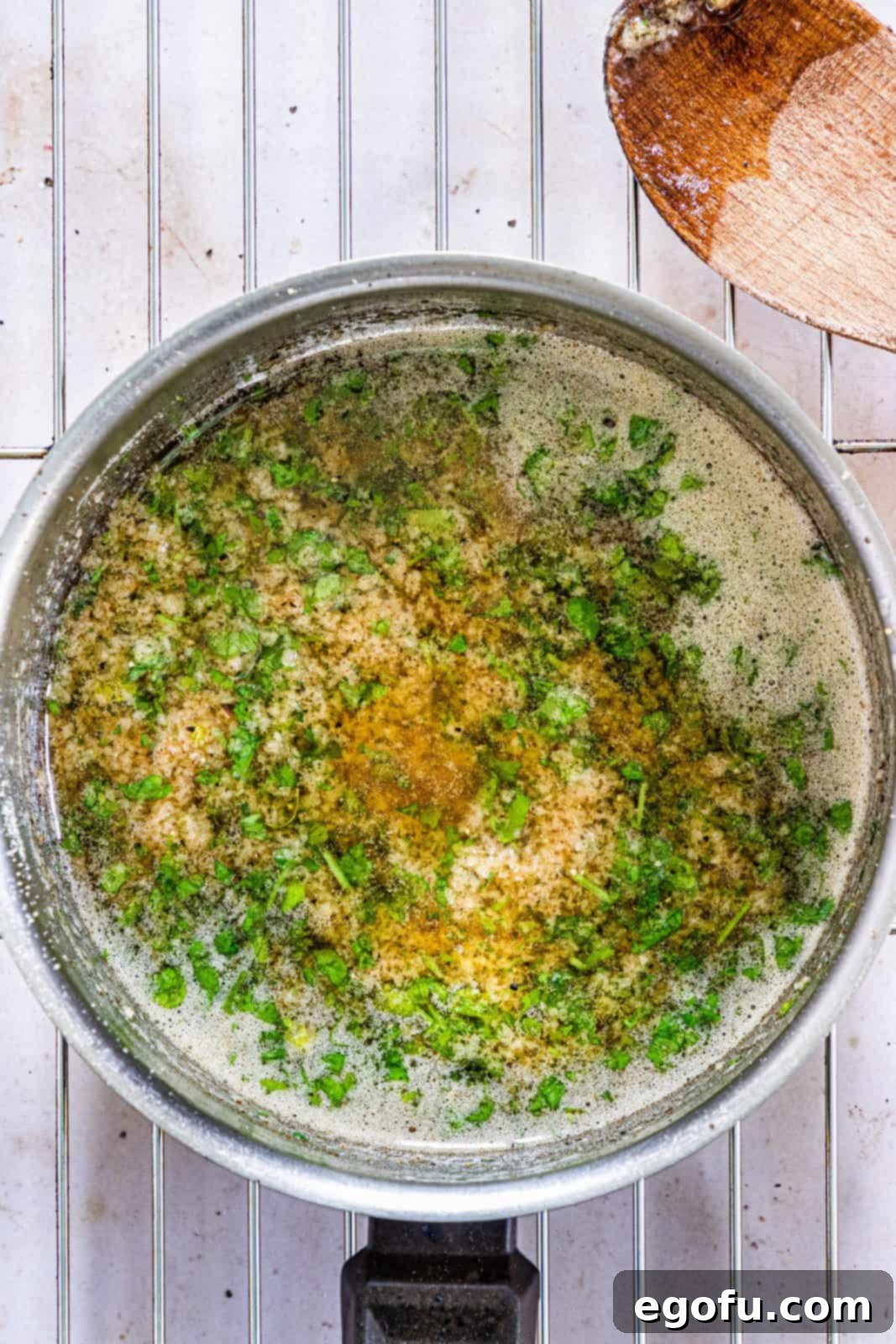 Garlic Butter Sheet Pan Chicken Dinner 8 Garlic, parsley, salt and black pepper added to browned butter in pan.