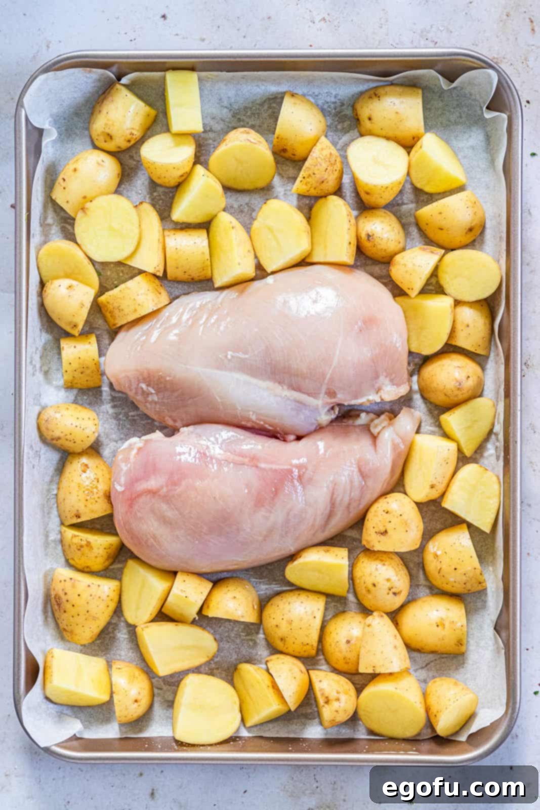 Garlic Butter Sheet Pan Chicken Dinner 9 Chicken breasts and potatoes on sheet pan.