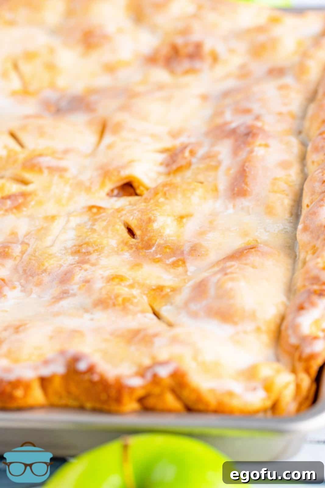 The finished, perfectly glazed Apple Slab Pie still in its baking pan.