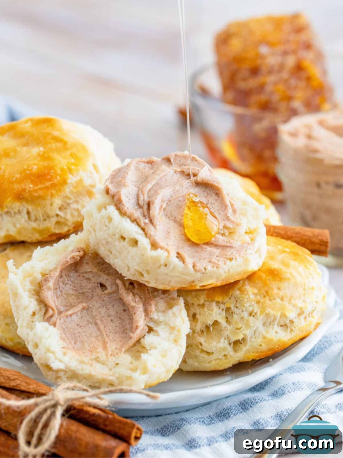 Texas Roadhouse Signature Cinnamon Honey Butter 2 Split biscuits with Texas Roadhouse Cinnamon Honey Butter spread on with a drizzle of honey.