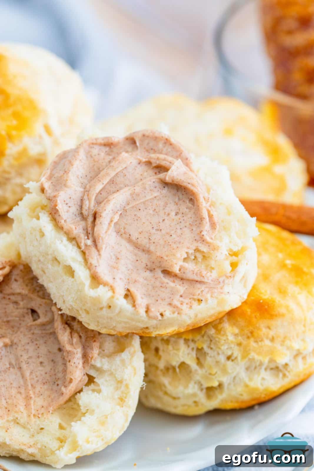 Texas Roadhouse Signature Cinnamon Honey Butter 7 Close up of one split biscuit sprerad with Texas Roadhouse Cinnamon Honey Butter.