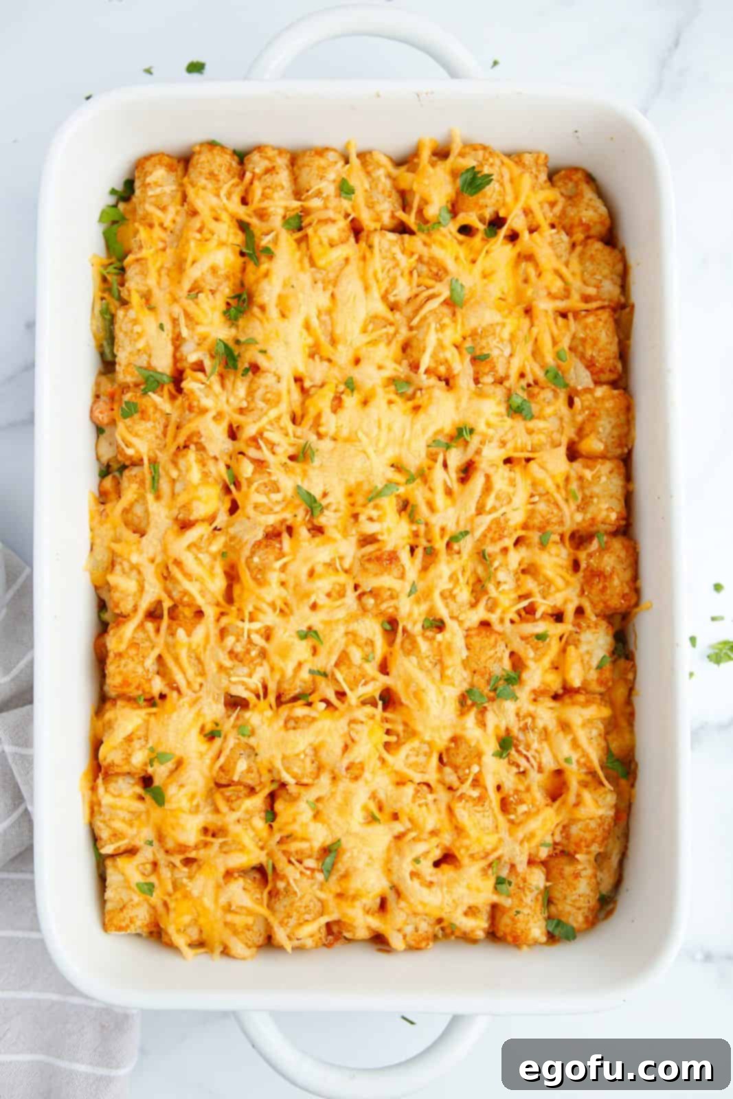 Overhead photo of Chicken Tater Tot Pot Pie right out of oven and garnished.