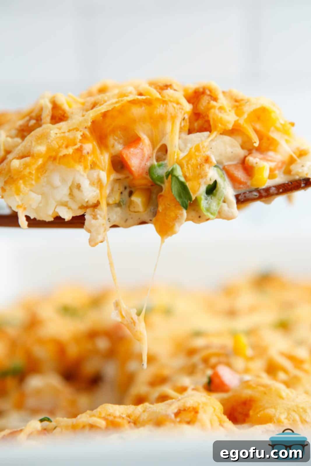 Wooden server holding up some of the Tater Tot Chicken Pot Pie.