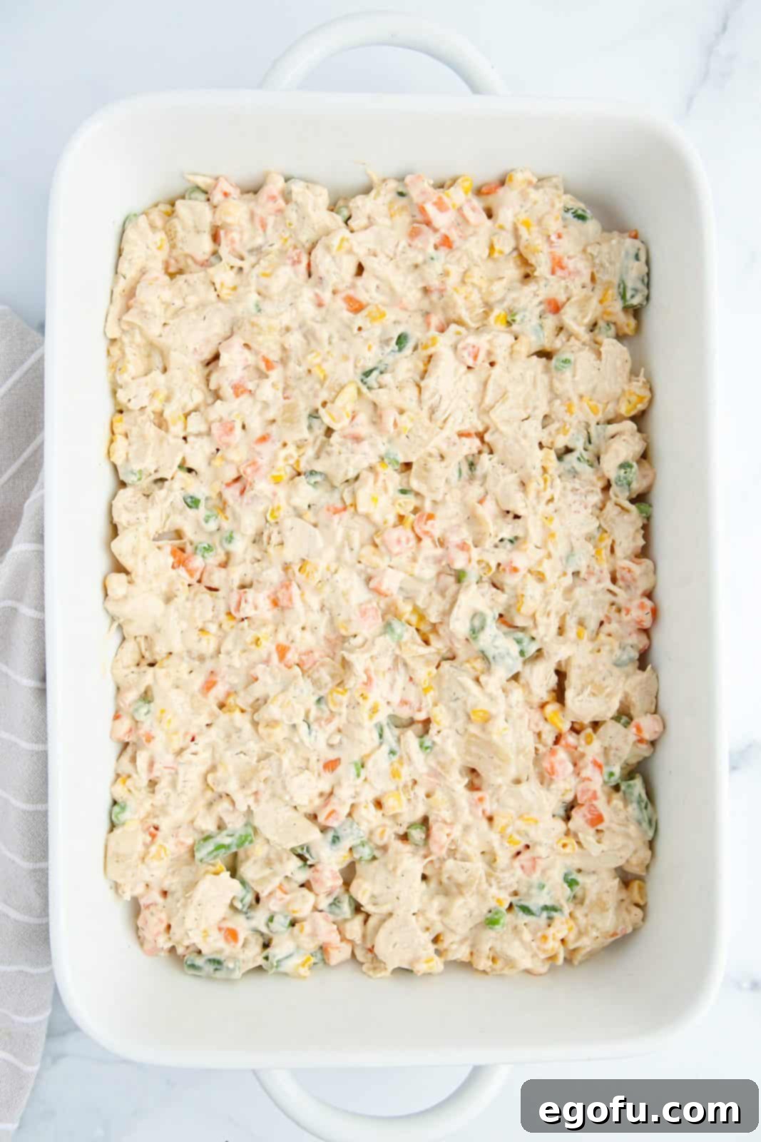 Pot Pie mixture spread into baking dish.