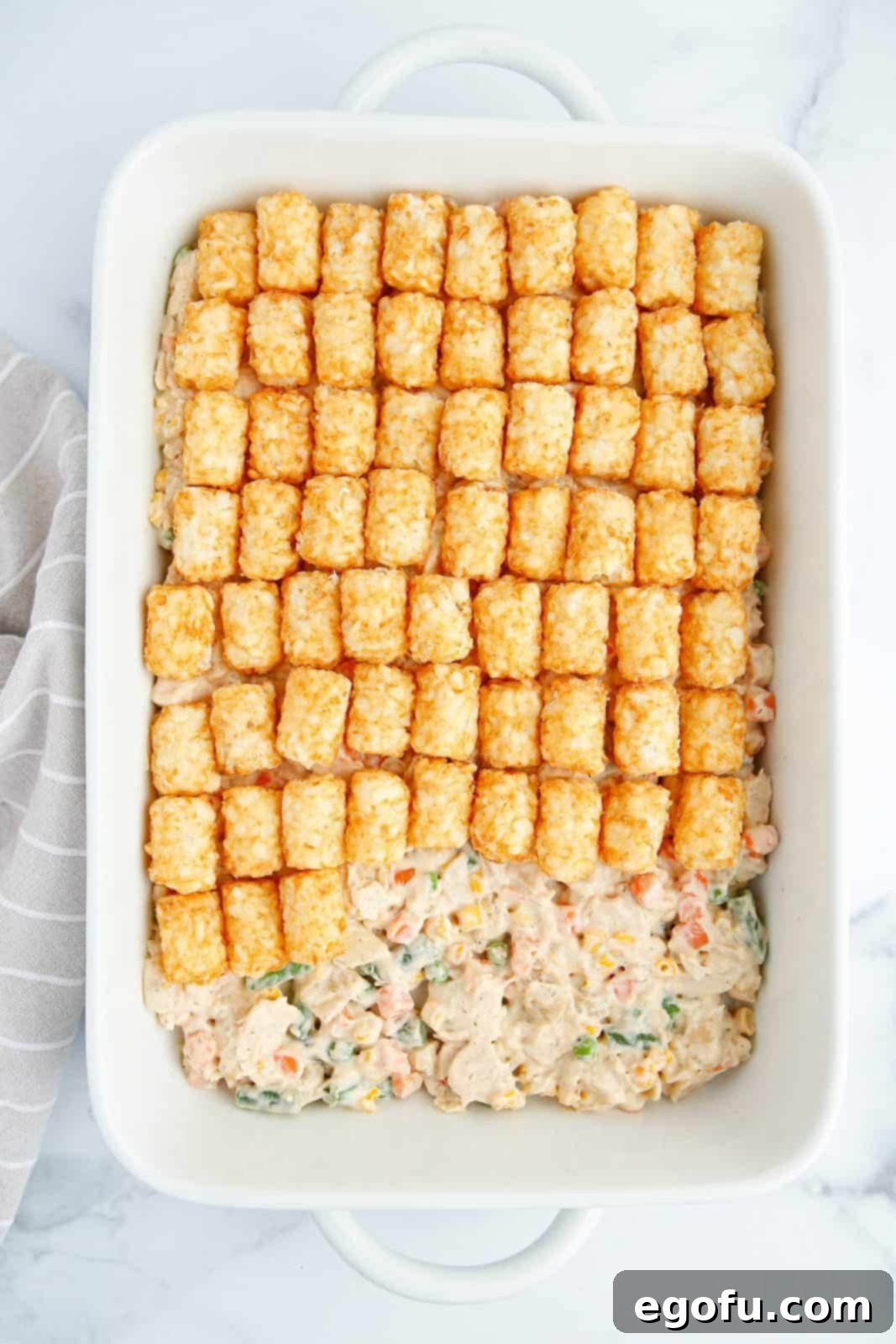 Tater Tots placed over pot pie mixture.