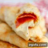 Stuffed Pizza Breadsticks 12 Square image of stacked Pizza Roll Breadsicks showing inside of one roll.