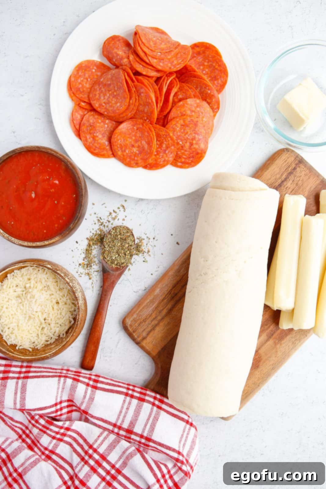 Stuffed Pizza Breadsticks 4 Ingredients needed: prepared pizza dough, pepperoni slices, mozzarella cheese sticks, unsalted butter, dried italian seasoning, parmesan cheese, parsley, marinara sauce and cooking spray.
