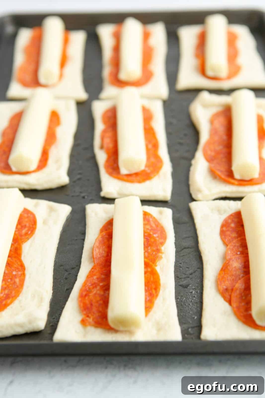 Stuffed Pizza Breadsticks 7 String cheese placed on top of pepperoni slices.