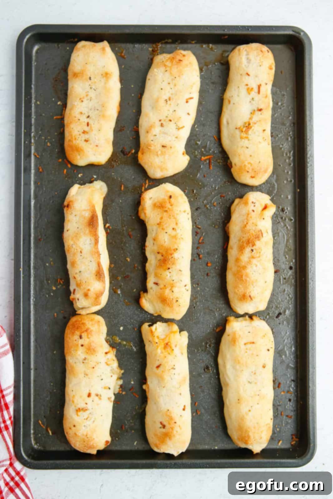 Stuffed Pizza Breadsticks 10 Baked Pepperoni Roll Breadsticks on baking sheet.