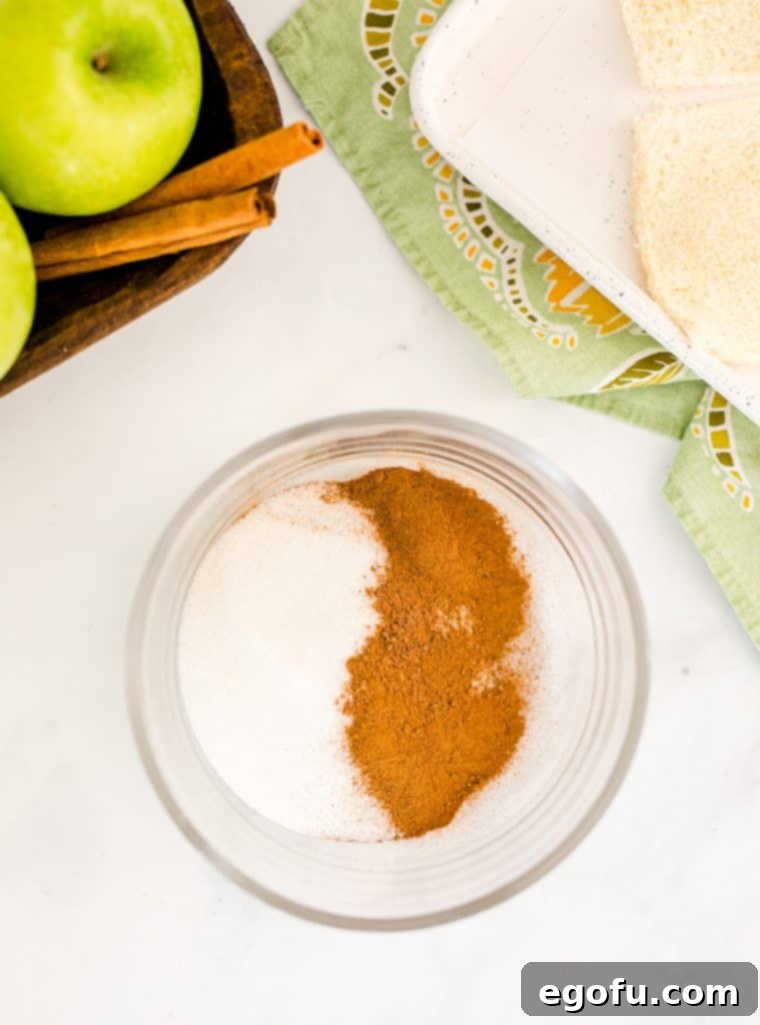 A small bowl holding a perfectly mixed blend of granulated sugar, aromatic cinnamon, and fragrant nutmeg, ready for coating.