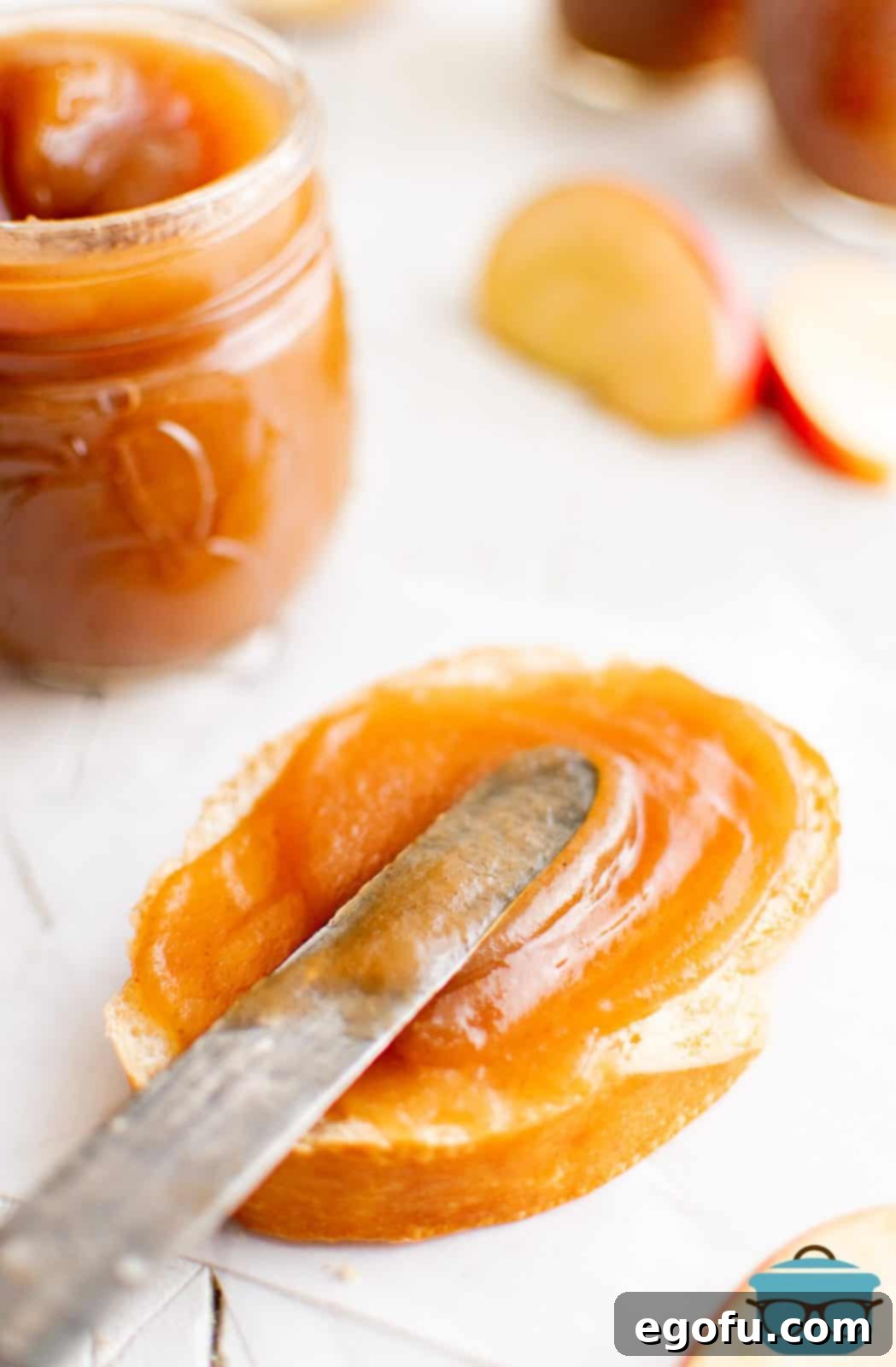 Slow Cooker Apple Butter being spread on bread with knife.