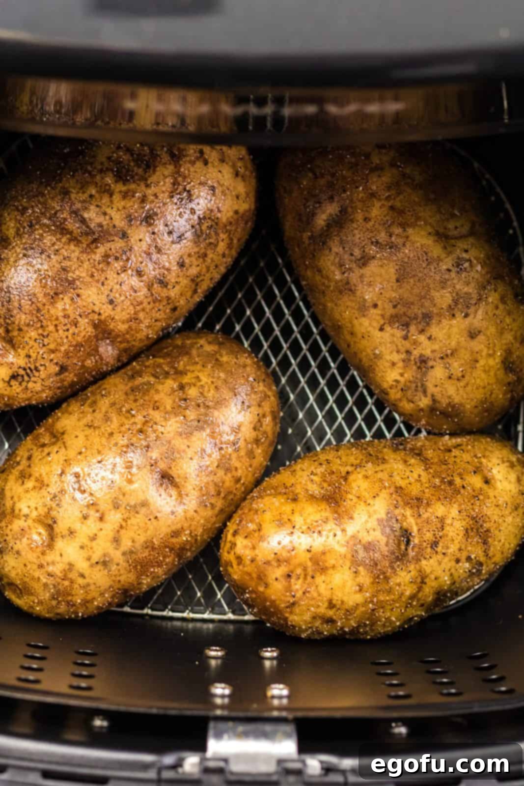 Baked Potatoes placed in air fryer.