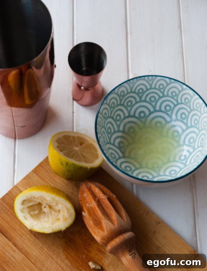 Freshly squeezed lemon juice in a bowl, ready for cocktail preparation.