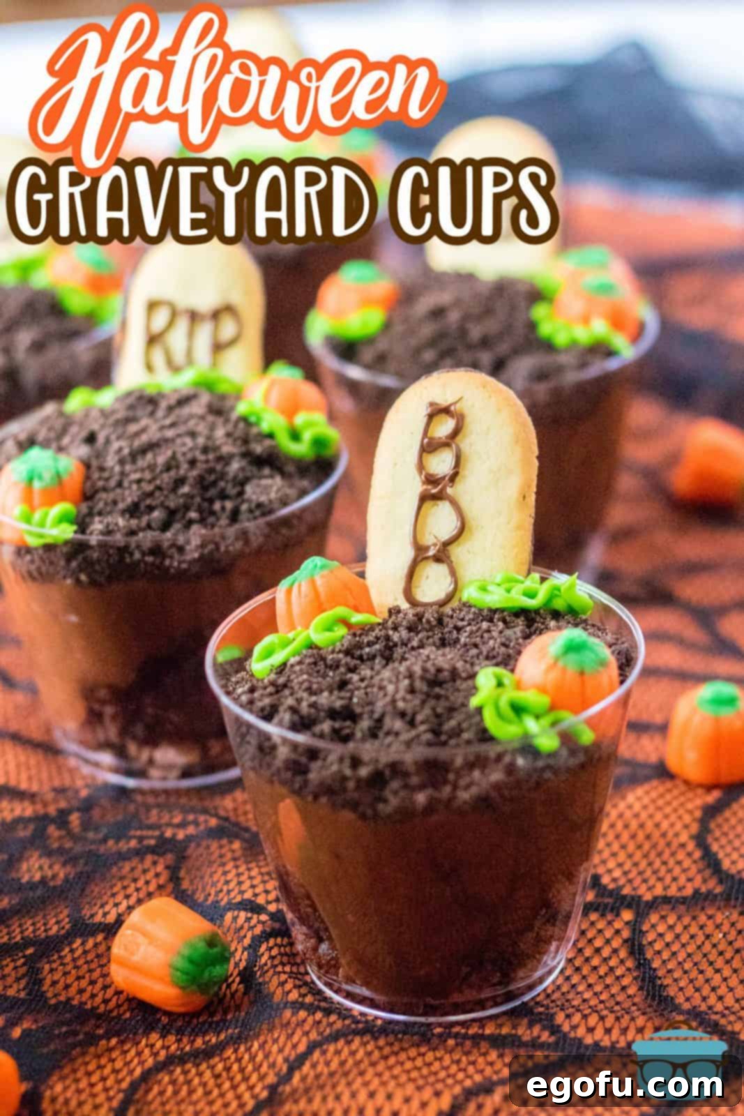 Close up of Halloween Graveyard Cups shown on orange and black lace, highlighting the details.