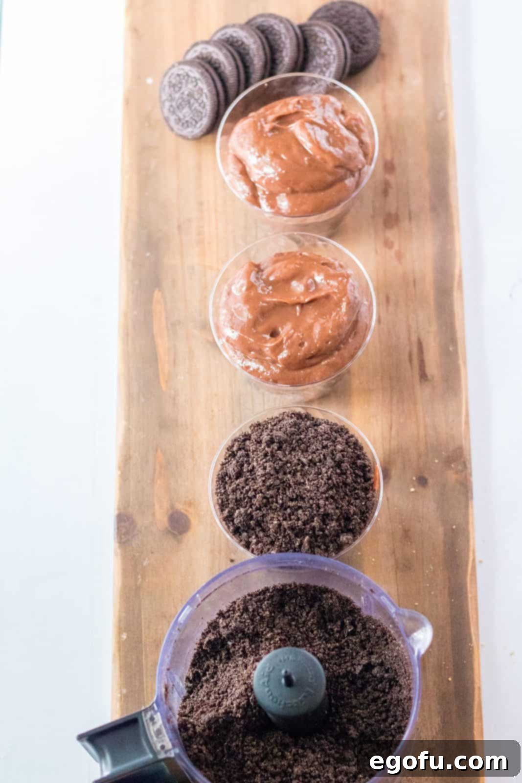 Oreo cookies crushed in food processor and added to the top of the pudding in the cups, forming the 'dirt' layer.