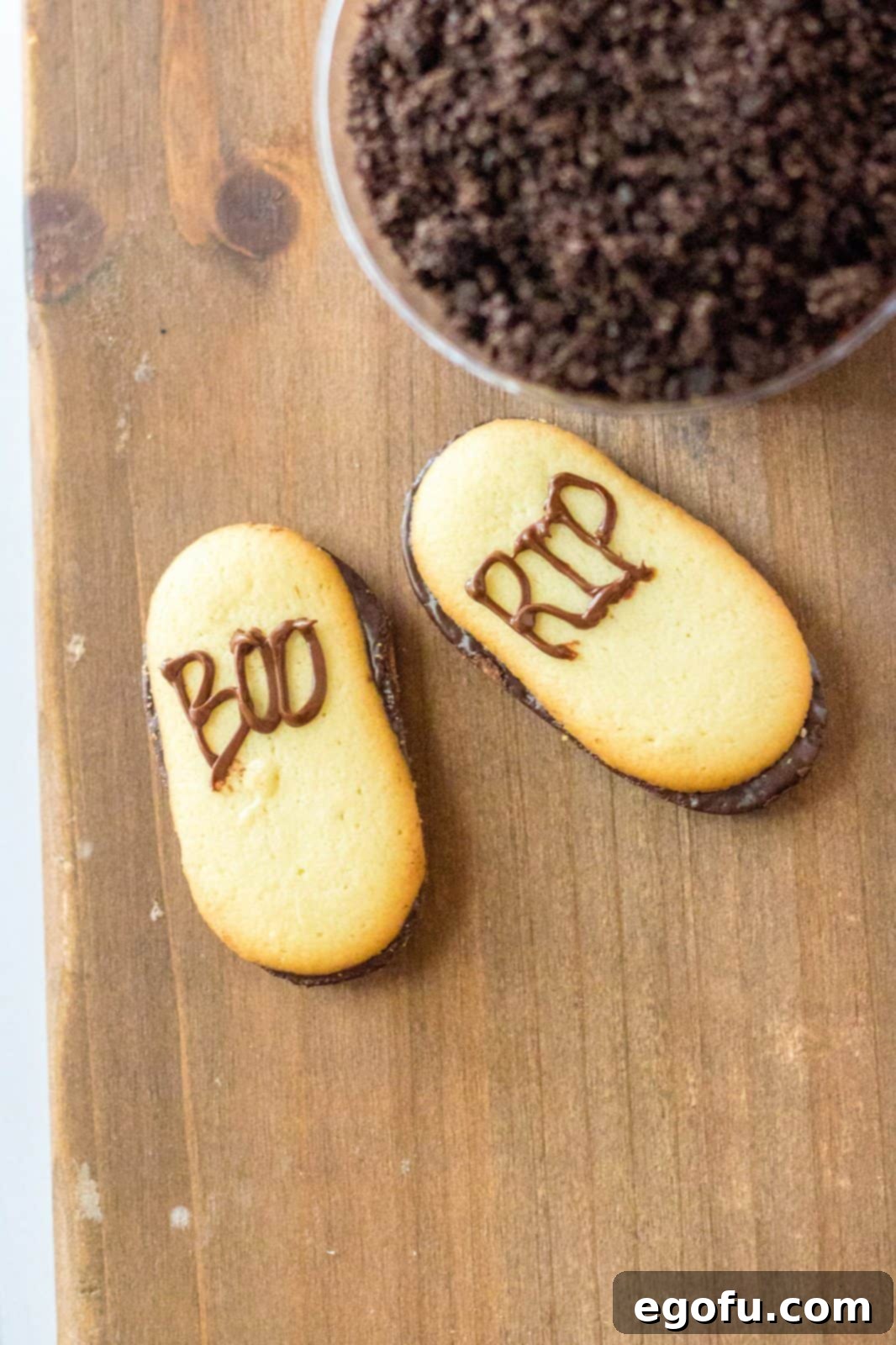 The words "Boo" and "R.I.P" piped onto Milano cookies, transforming them into edible tombstones.