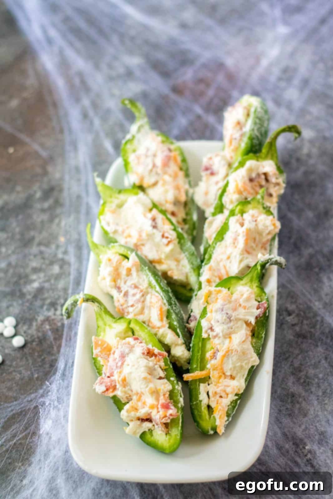 Mummy-Wrapped Jalapeño Poppers 5 Sliced jalapenos filled with cheese and bacon mixture.