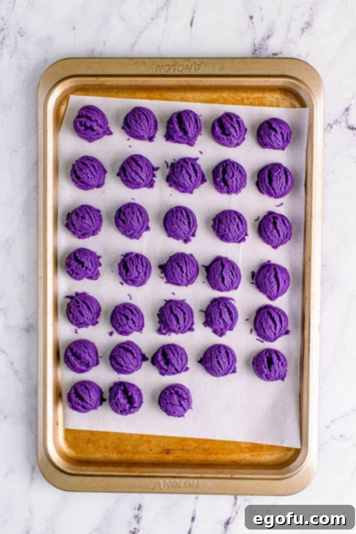 Cookie dough shaped and placed on lined baking sheet, ready for chilling.