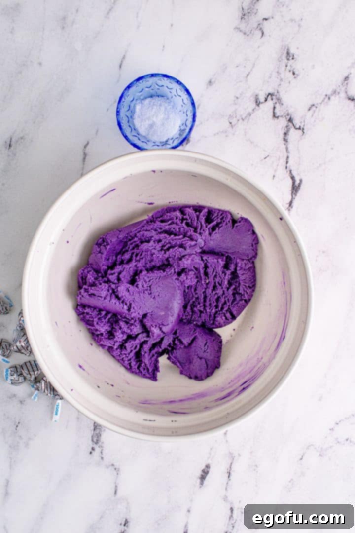 Food coloring added to dough and mixed in, resulting in a vibrant purple cookie dough.