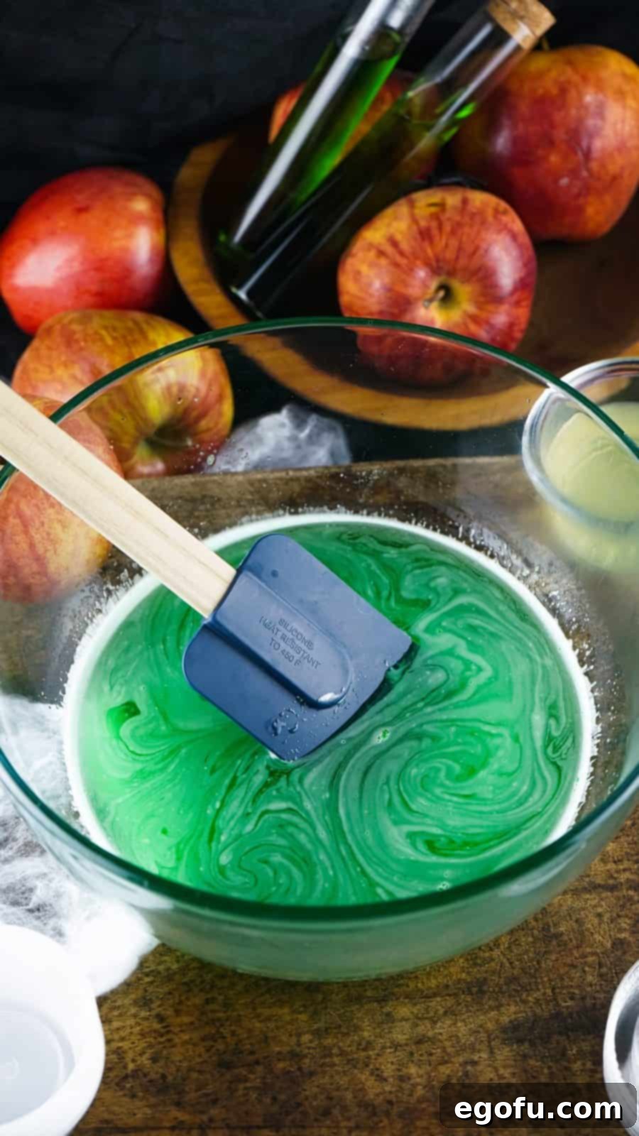 Jell-o and boiling water added to bowl being stirred.