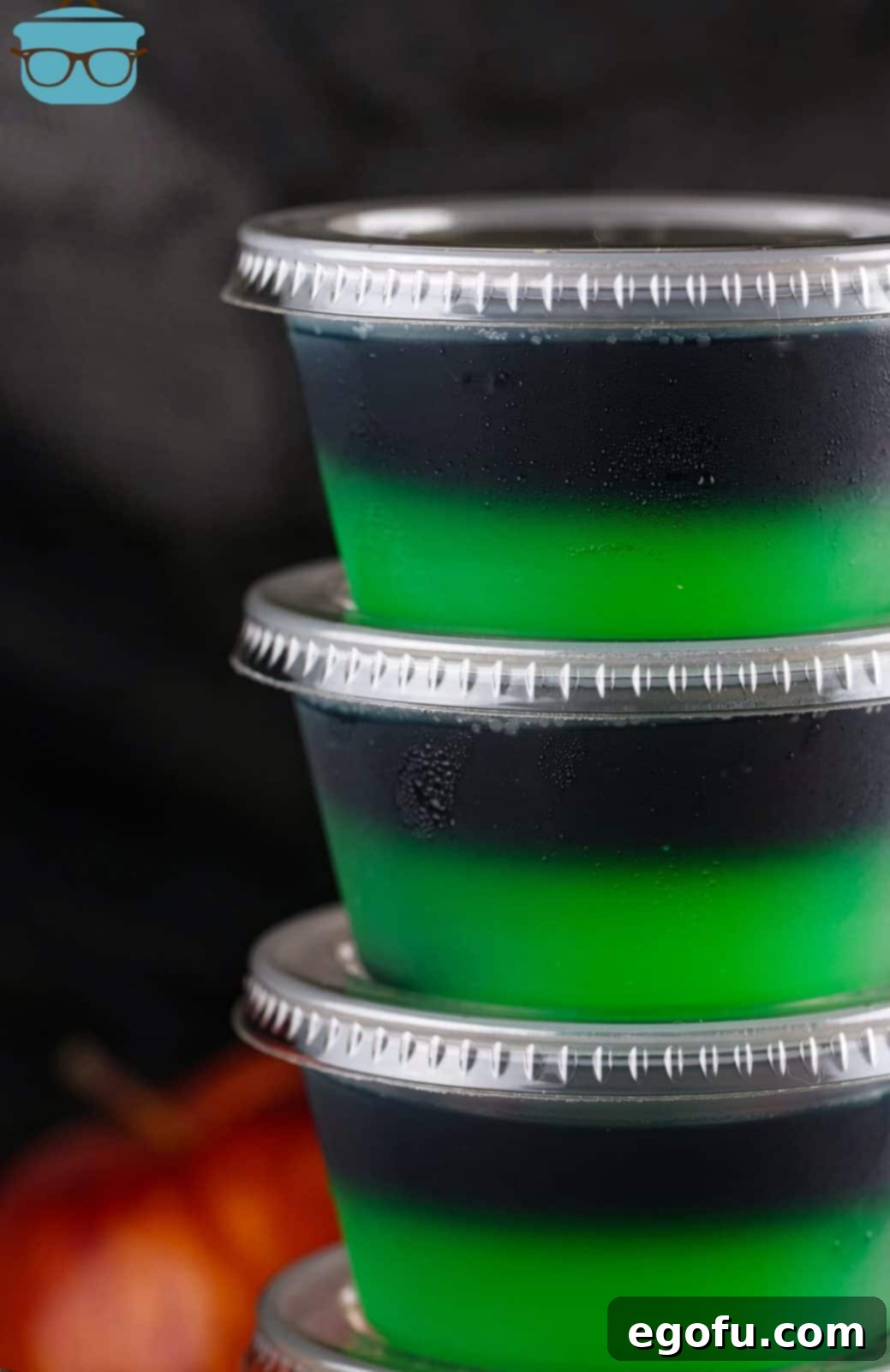 Close up of sides of stacked Halloween Poison Apple Jell-O Shots.