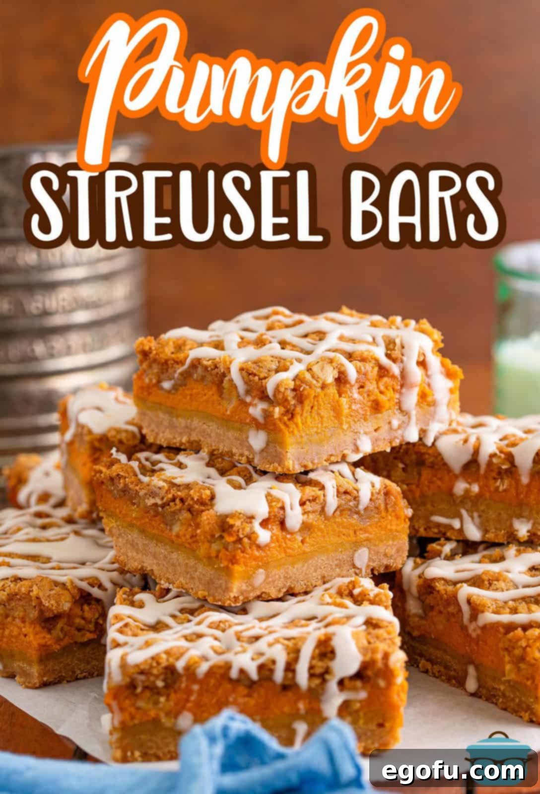 Stacked pumpkin bars on a piece of white parchment paper with an old-fashioned flour sifter in the background, highlighting the rustic, homemade appeal.