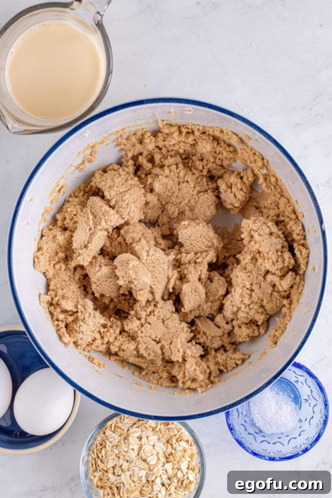 The dry and wet ingredients for the crust are mixed until just combined, forming a cohesive dough.