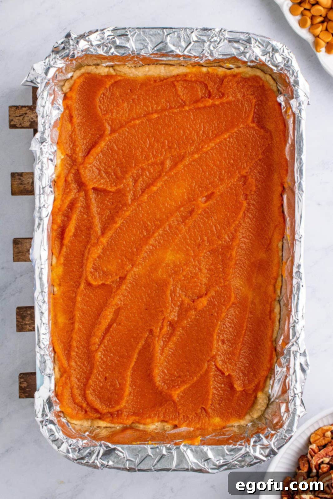 Autumn Magic Pumpkin Bars 8 Smooth layer of pumpkin pie filling spread over the pre-baked crust in the baking pan.