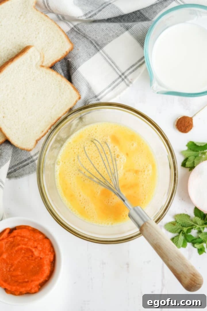 Eggs being whisked in bowl.