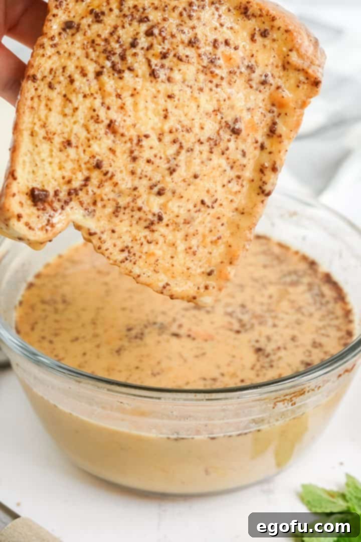 Bread being dipped into the egg mixture.