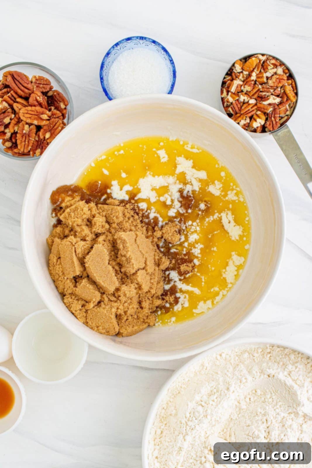 Sugar and butter added to white separate white bowl.