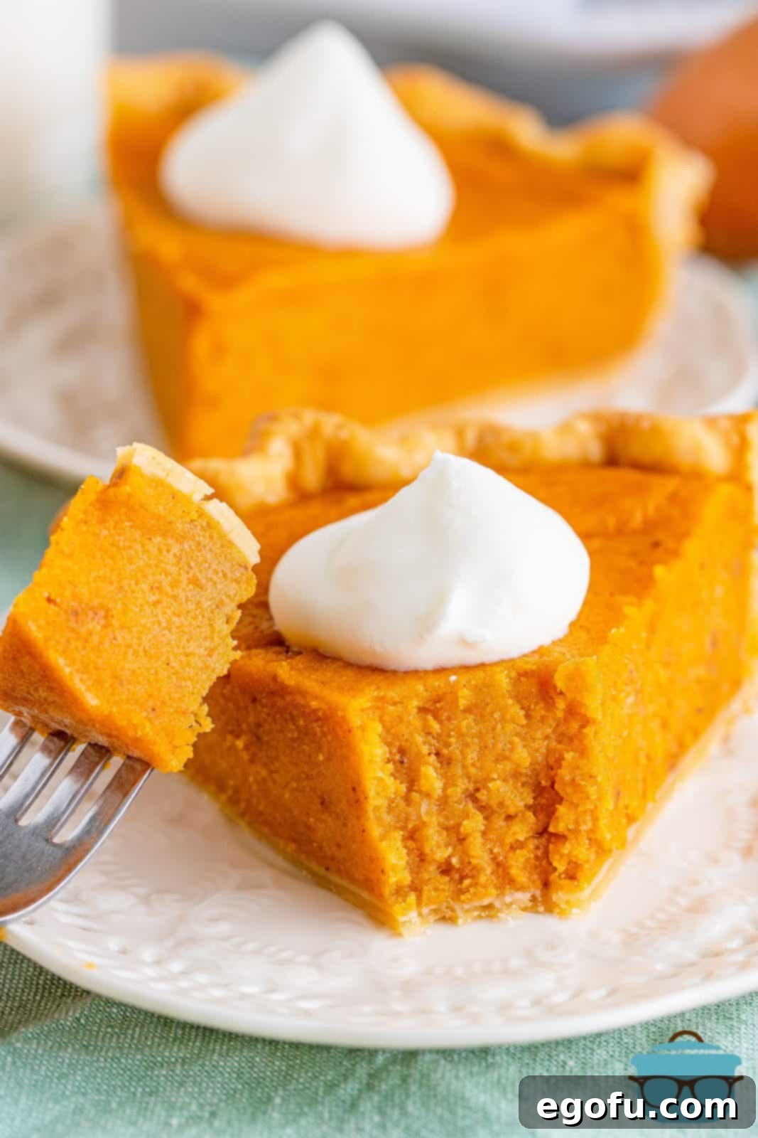 Velvet Sweet Potato Dream Pie 2 Sweet Potato Pie on plate with fork bite taken out of it.