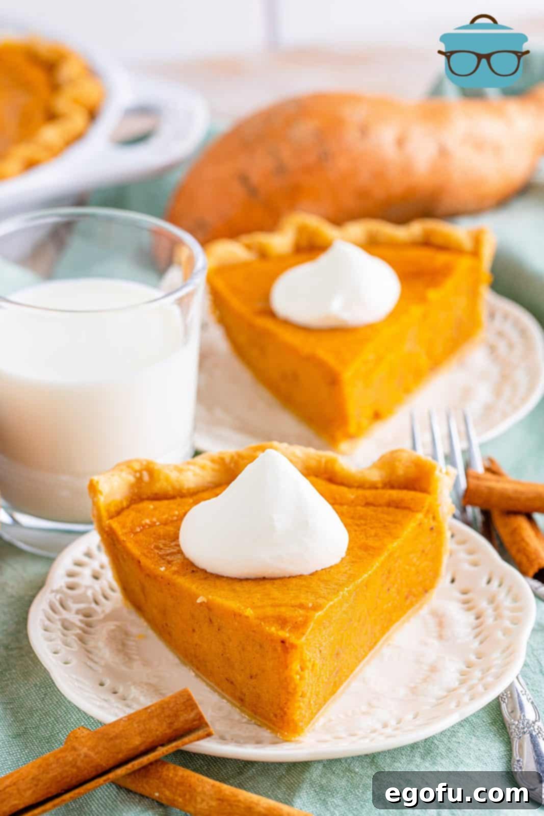 Velvet Sweet Potato Dream Pie 13 Two slices of Sweet Potato Pie on white plates with dollops of whipped cream.