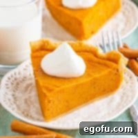 Velvet Sweet Potato Dream Pie 14 Square image of one slice of Sweet Potato Pie on plate with whipped cream.