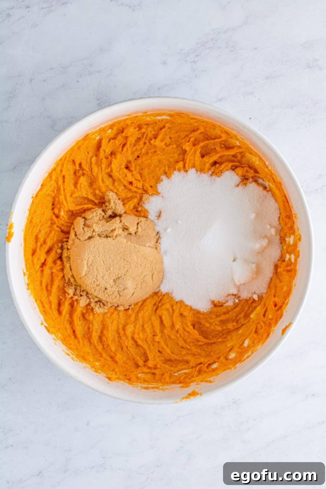 Velvet Sweet Potato Dream Pie 7 Brown sugar and granulated sugar added to sweet potato mixture in bowl.