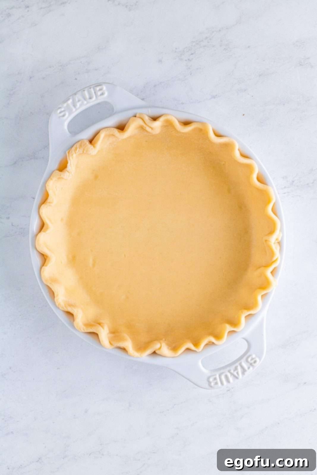 Velvet Sweet Potato Dream Pie 10 Pie crusted placed in pie plate and edges fluted.