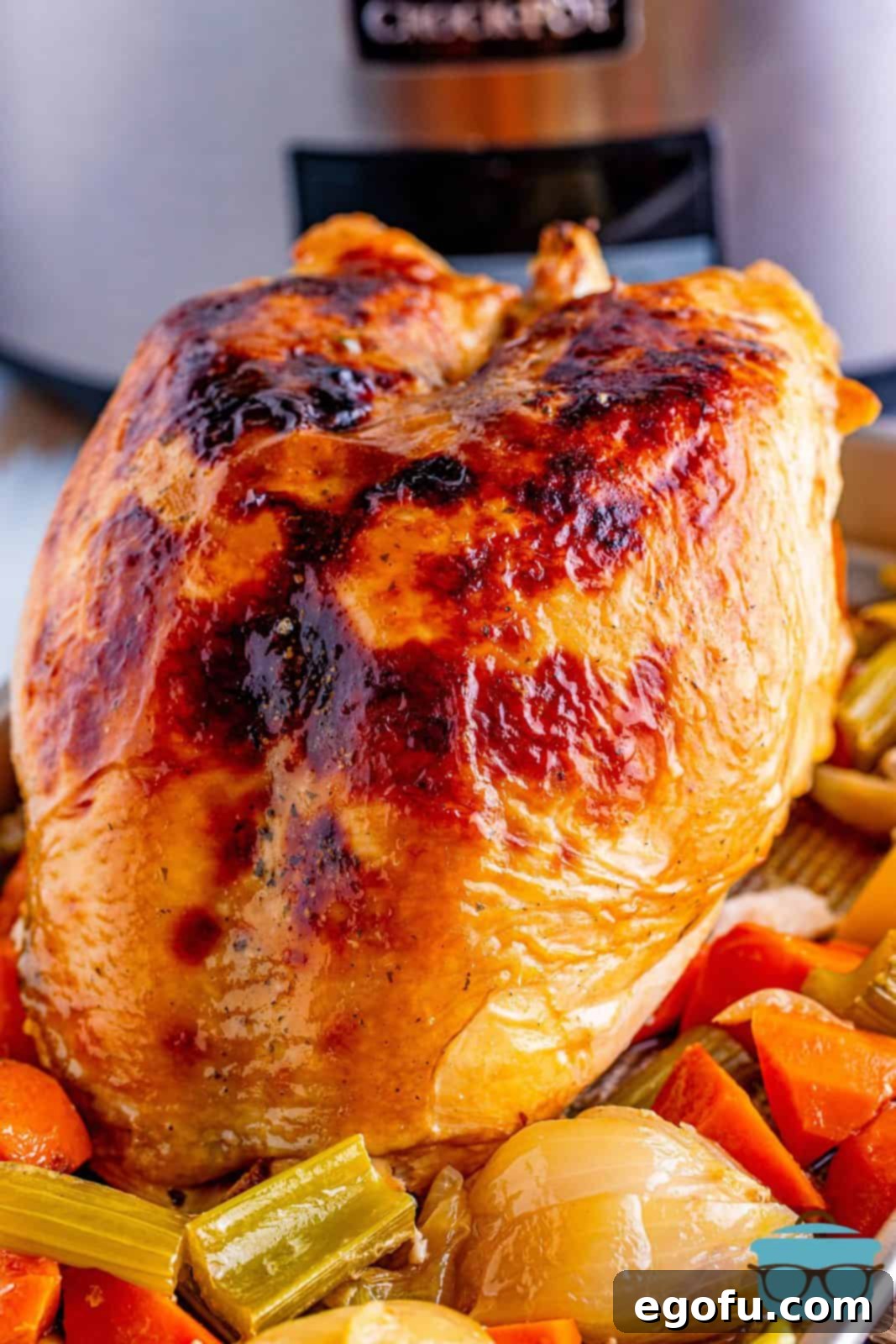 Finished Crock Pot Mississippi Turkey Breast on platter with vegetables, ready to serve.