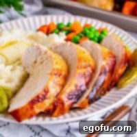 Square image of sliced and plated Crock Pot Mississippi Turkey Breast.