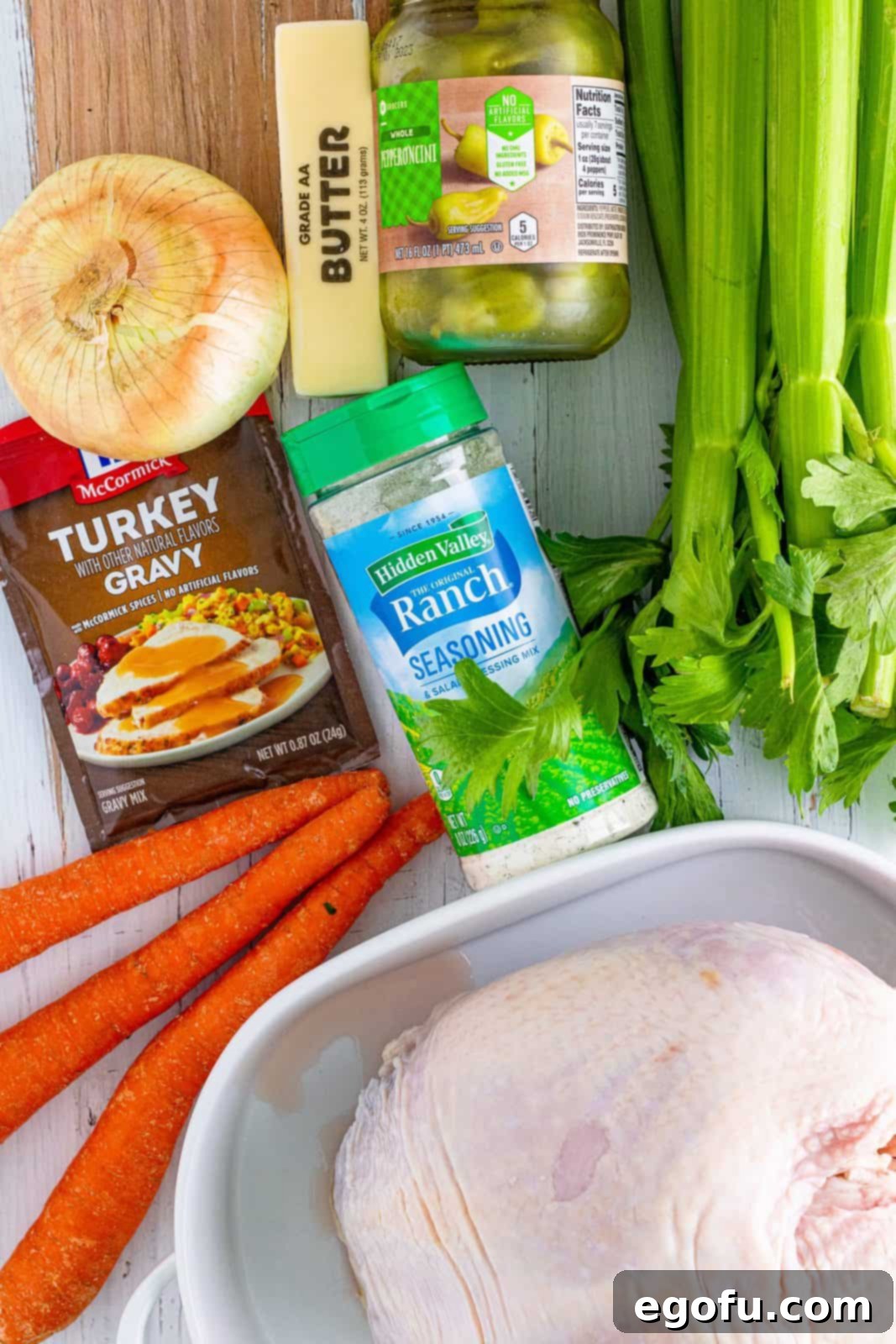 Ingredients needed for Crock Pot Mississippi Turkey Breast: Carrots, celery, onion, turkey breast, turkey gravy mix, dried ranch seasoning, unsalted butter, and pepperoncini peppers.