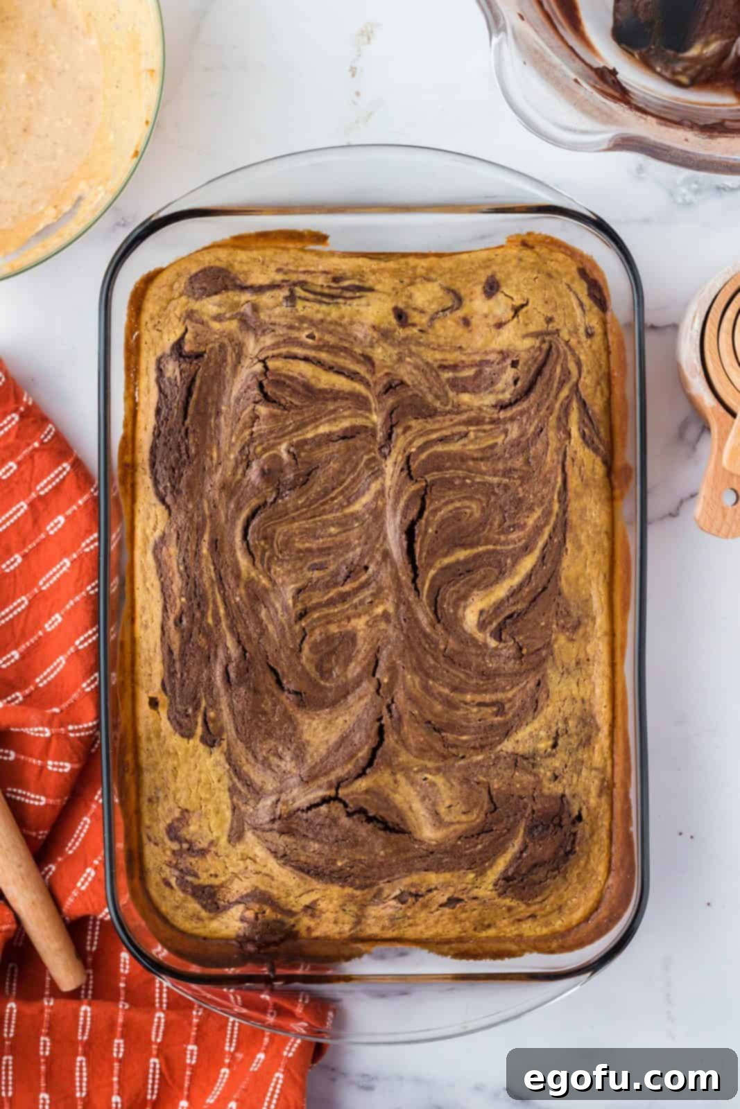 The finished Pumpkin Swirl Brownies, golden brown and perfectly baked, fresh out of the oven in the baking pan.