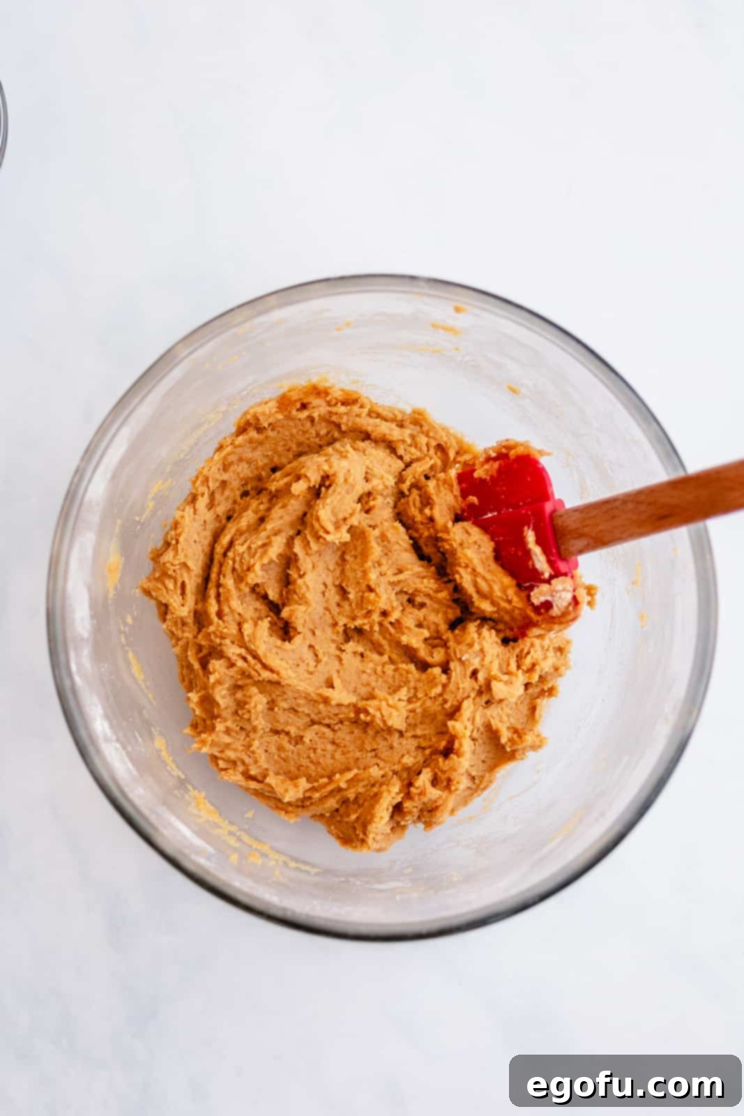 Pumpkin mixture being mixed together with dry ingredeints.