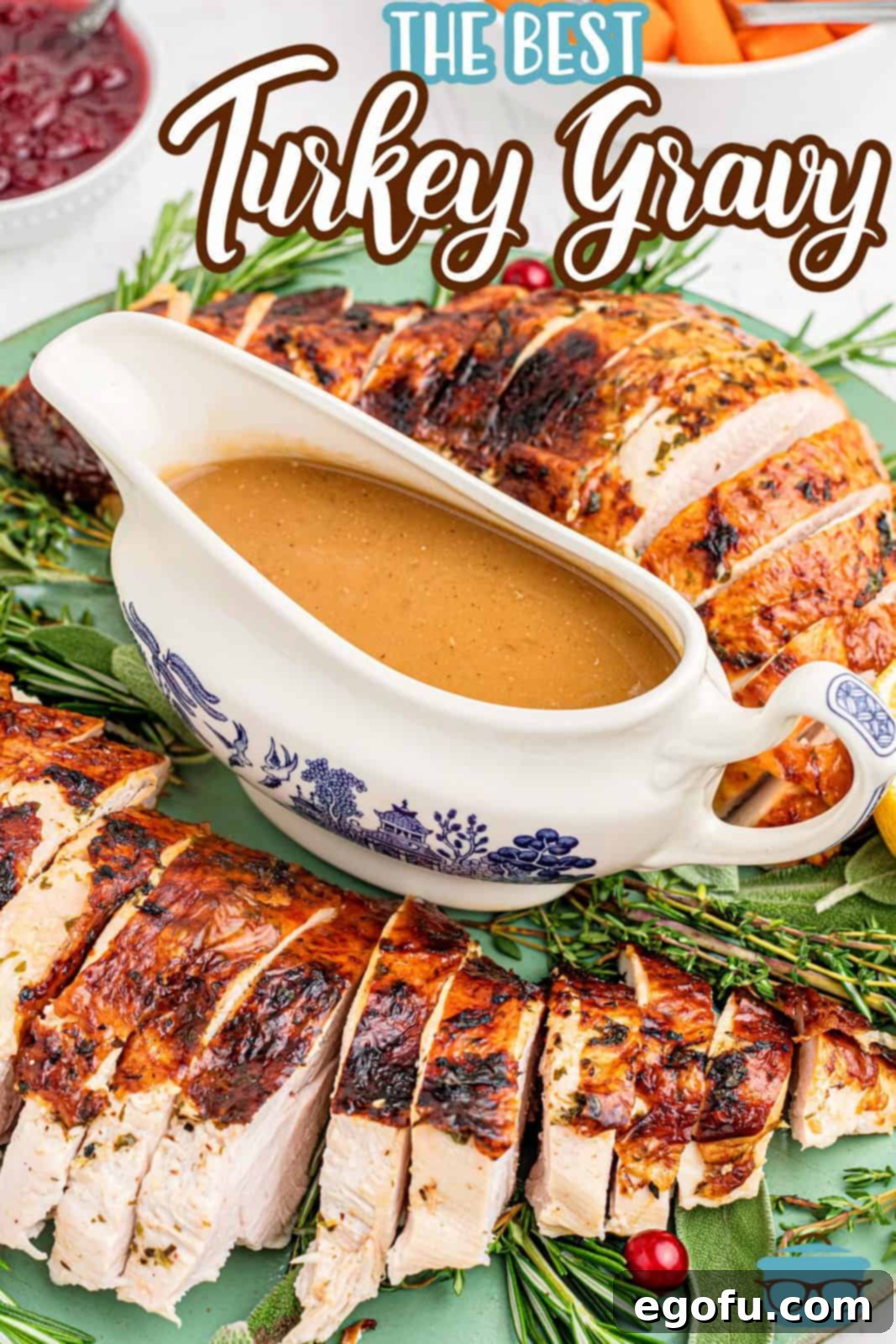 The Definitive Turkey Gravy 3 A beautifully arranged gravy boat filled with The Best Turkey Gravy, placed on a festive platter with roasted turkey and fresh herbs, ready for a holiday spread.