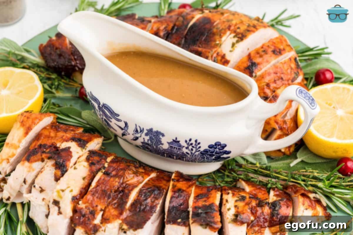 The Definitive Turkey Gravy 8 The Best Turkey Gravy Recipe, perfectly finished and presented in an elegant gravy boat, ready to be served alongside a succulent roast turkey, garnished with fresh herbs.