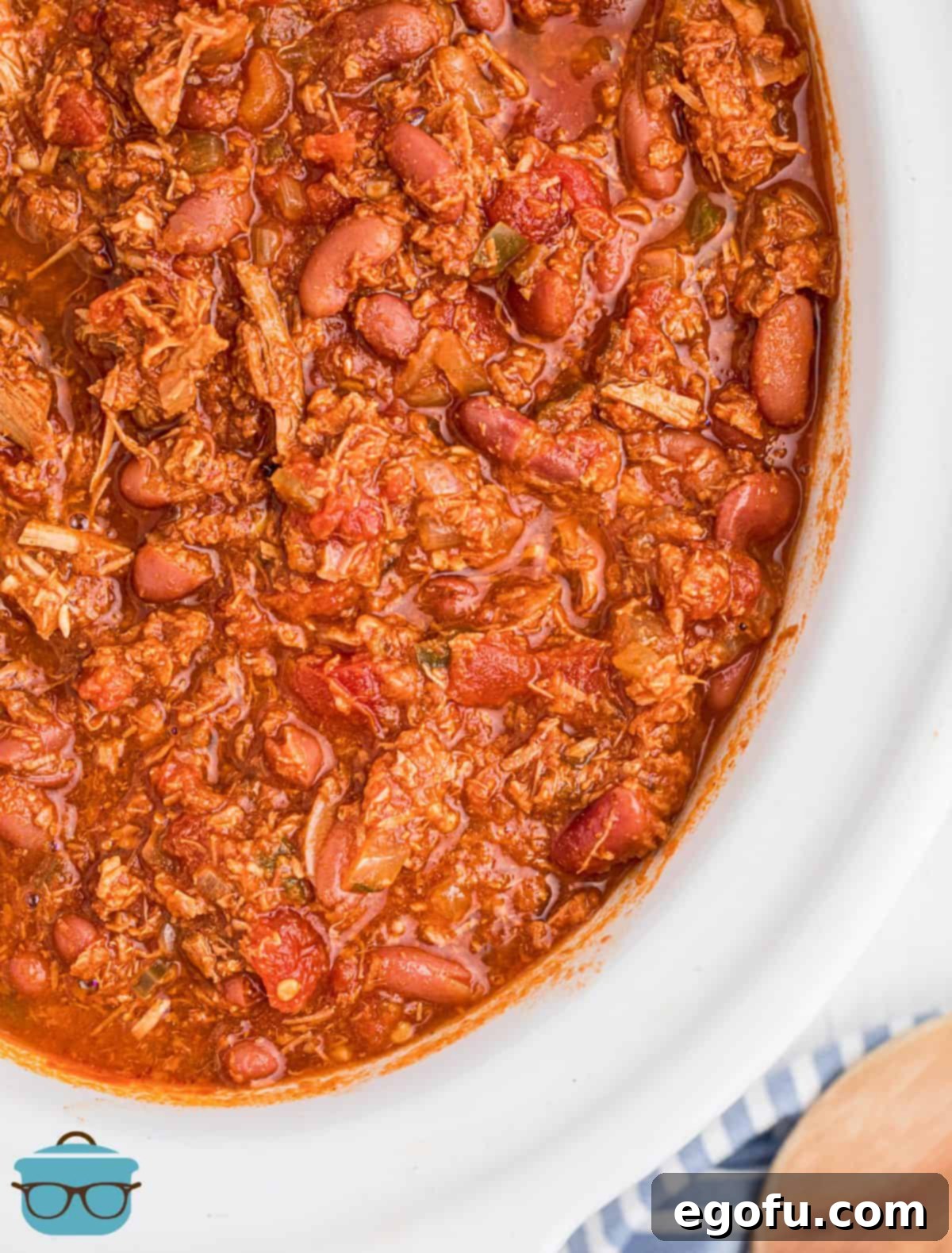 Overhead close up of Crock Pot Turkey Chili in crock pot, showcasing its rich texture and vibrant colors.