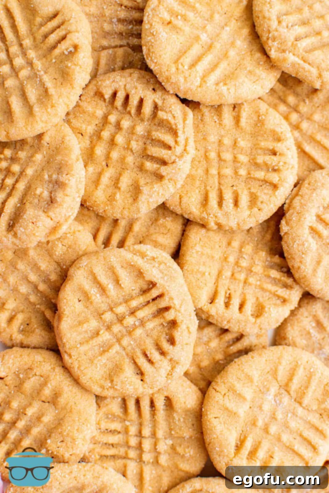 Close up stacked photo of perfectly baked, soft, and chewy 3-Ingredient Peanut Butter Cookies, highlighting their irresistible texture.