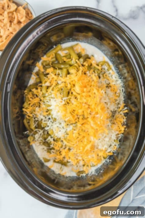 green beans, cheeses and seasoning added to slow cooker.
